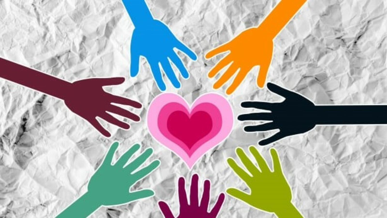 Multi colored hands reaching for a heart